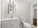 Updated bathroom with white vanity, toilet and mirror at 147 Hermer Nw Cir, Atlanta, GA 30311