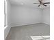 Spacious bedroom with ceiling fan and grey carpeting at 163 Strawbridge Trce, Lawrenceville, GA 30044