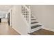 Modern staircase with dark wood steps and white railing at 2317 Rocksram Ct, Buford, GA 30519