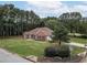 Single-story brick home nestled in a wooded neighborhood at 3020 Templeton Ln, Loganville, GA 30052