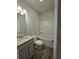 Bathroom with granite countertop vanity, tub, and gray flooring at 3233 Greenhill Dr, Villa Rica, GA 30180