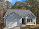New single-story home with gray siding, white garage door, and landscaping at 3233 Greenhill Dr, Villa Rica, GA 30180