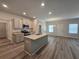 Modern kitchen with gray cabinets, granite island, and stainless steel appliances at 3233 Greenhill Dr, Villa Rica, GA 30180