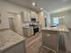 Open kitchen with island, granite countertops, and stainless steel appliances at 3233 Greenhill Dr, Villa Rica, GA 30180