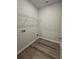 Laundry room with built-in shelving and vinyl flooring at 3233 Greenhill Dr, Villa Rica, GA 30180