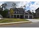 Two-story house with gray siding, stone accents, and a three-car garage at 5275 Flannery Chase Sw, Powder Springs, GA 30127