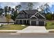 Two-story house with gray siding, stone accents, and a three-car garage at 5275 Flannery Chase Sw, Powder Springs, GA 30127