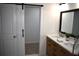 Modern bathroom boasts dual vanities, a barn door, and an updated look at 776 Sugar Creek Se Trl, Conyers, GA 30094