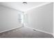 Well-lit bedroom with grey carpet and two large windows at 5555 Christi Dr, Douglasville, GA 30135