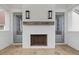 Outdoor fireplace with white brick and stone flooring at 11273 Serenbe Ln, Chattahoochee Hills, GA 30268