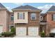 Brick front exterior of a two-story townhome with a two-car garage at 2368 Harshaw Ave # 166, Lawrenceville, GA 30043