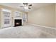 Living room with fireplace, carpet, and access to patio at 2368 Harshaw Ave # 166, Lawrenceville, GA 30043