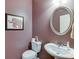 Small powder room with pedestal sink and oval mirror at 3393 Sardis Bend Dr, Buford, GA 30519