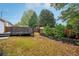 Fenced backyard with mature trees and manicured lawn at 1475 Diplomat Dr, Cumming, GA 30041