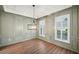 Bright dining room features wood floors, wainscoting, plantation shutters and a chandelier at 1475 Diplomat Dr, Cumming, GA 30041