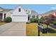 All-white charming house with a two-car garage and manicured lawn at 1475 Diplomat Dr, Cumming, GA 30041