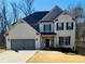 Two-story house with gray double garage and brick facade at 211 Alderleaf Ct, Mcdonough, GA 30252