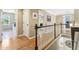 Upstairs hallway with hardwood floors and laundry access at 3950 Stanford Dr, Cumming, GA 30041