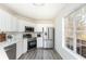 Bright kitchen with stainless steel appliances and white cabinets at 700 Robert Ln, Canton, GA 30114