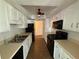 Galley kitchen with black appliances and light cabinets at 3001 Canyon Point Cir, Roswell, GA 30076