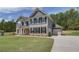 Two-story home with gray siding, brick accents, and a landscaped lawn at 62 Homesite Cooper W Cv, Fayetteville, GA 30215