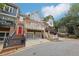 Three story townhome with stone and wood exterior, multiple balconies, and two-car garage at 1505 Whitehead Nw Blf, Atlanta, GA 30318