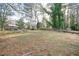 Large backyard with mature trees and open grassy area at 2198 Star Mist Sw Dr, Atlanta, GA 30311