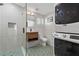 Modern bathroom with stackable washer and dryer, a walk-in shower and hexagon tile at 468 Pasley Se Ave, Atlanta, GA 30316