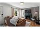 Living room with fireplace, large window, and comfy seating at 468 Pasley Se Ave, Atlanta, GA 30316