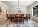 Formal dining room boasts a large table, chandelier, and hardwood floors at 530 Penny Ln, Loganville, GA 30052