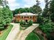 Brick home with circular driveway and manicured landscaping at 3370 Habersham Nw Rd, Atlanta, GA 30305