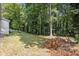 Spacious backyard with large trees and a fenced area at 4218 Tara Dr, Forest Park, GA 30297