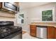Kitchen boasts stainless steel appliances and wood cabinetry at 4218 Tara Dr, Forest Park, GA 30297