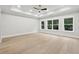 Large bedroom with hardwood floors and three windows at 3165 Hall Rd, Dacula, GA 30019