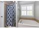 Bathroom features a soaking tub, shower, and window at 502 Spirlet Ct, Woodstock, GA 30188