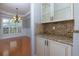 Butlers pantry with granite countertops and glass-front cabinets at 502 Spirlet Ct, Woodstock, GA 30188