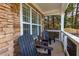 Relaxing front porch with wooden chairs and stone accents at 502 Spirlet Ct, Woodstock, GA 30188