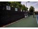 Tennis court with fence showing awards and name at 502 Spirlet Ct, Woodstock, GA 30188