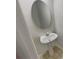 Clean bathroom featuring a pedestal sink and an oval mirror at 2491 Emma Way, Lawrenceville, GA 30044