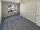 Bright bedroom featuring gray carpet and a large window at 2491 Emma Way, Lawrenceville, GA 30044