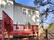 Red deck overlooks wooded area with privacy fence at 2491 Emma Way, Lawrenceville, GA 30044