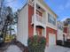 Townhouse with brick and siding exterior, balcony, and garage at 2491 Emma Way, Lawrenceville, GA 30044