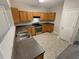 Kitchen with stainless steel appliances and wood cabinets at 2491 Emma Way, Lawrenceville, GA 30044