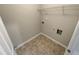 Bright laundry room with built-in shelving and vinyl flooring at 2491 Emma Way, Lawrenceville, GA 30044