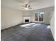 Spacious living room featuring a corner fireplace and carpet flooring at 2491 Emma Way, Lawrenceville, GA 30044