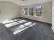 Bright and airy main bedroom with ample natural light and carpet flooring at 2491 Emma Way, Lawrenceville, GA 30044
