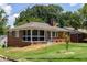 Brick ranch house with screened porch and landscaped yard at 417 Lynnhaven Sw Dr, Atlanta, GA 30310