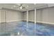 Spacious finished basement with stained concrete floors and ceiling fan at 5975 P W A Dr, Cumming, GA 30041