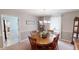 Round dining table with chairs is the centerpiece of this room, with kitchen view at 445 Hinton Rd, Social Circle, GA 30025