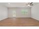 Bright living room with hardwood floors, ceiling fan, and access to deck at 7000 Fringe Flower Dr # 85, Austell, GA 30168